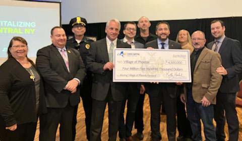 From left, Oswego County Legislator Mary Ellen Chesbro, Police Chief Martin Nerber, Police Sergeant Dan Ferazzoli, Phoenix Mayor Caleb Sweet, Deputy Mayor Paul Griser, Village Trustee Brian Borchik, Secretary of State Robert Rodriguez, Kristy LaManche, Village Administrator James Lynch, and Oswego County IDA CEO Austin Wheelock.